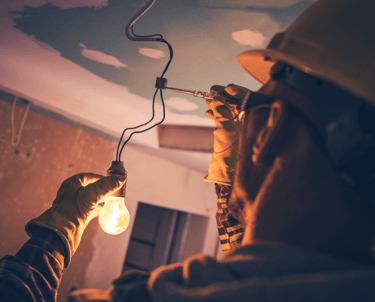 A licensed electrician in Comanche Tx testing the power with a volt meter at a remodel