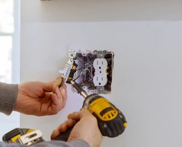 Electrician doing some finish out work on a customers house, changing out the electric switches