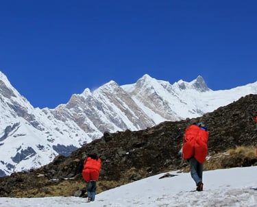 a group of people walking up a snowy mountain