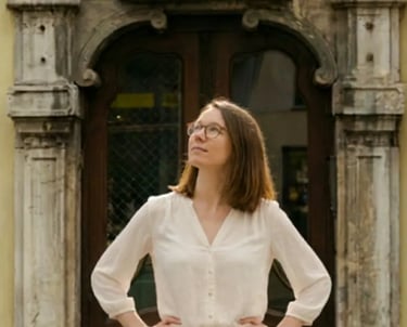 Woman posing in front of a historic stone doorway during a Graz photography tour.