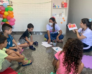 a group of children sitting on the floor in a circle