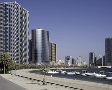 a city street with boats and buildings in the background