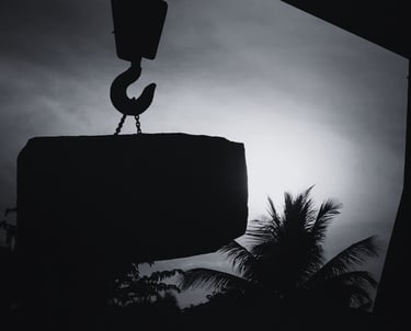 crane lifting granite block