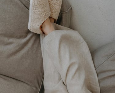 woman lying in pajamas and house shoes