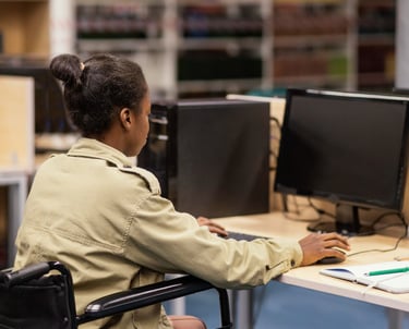 estudante em cadeira de rodas estudando na frente de computador