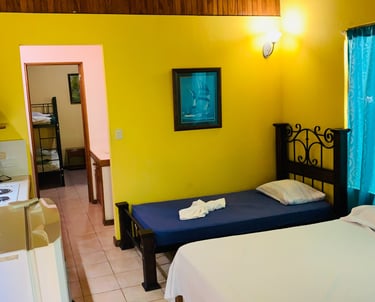 a bedroom with a bed and a kitchen