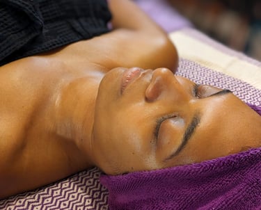 woman laying down getting a facial at a spa