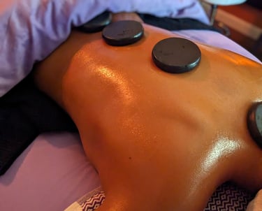hot stones laying on aback during a massage