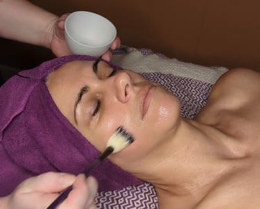 woman getting a mask during a facial treatment
