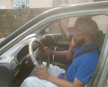 A student driver learning how to drive a a car at Triple A Global driving school in Lagos, Nigeria.