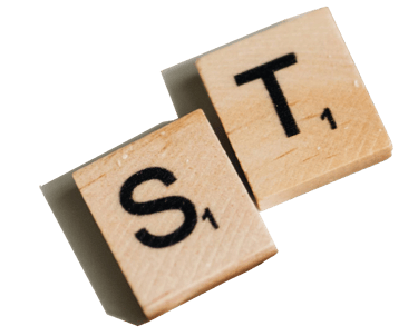 Two Scrabble tiles with letters "S" and "T," each with a score of 1 point, on a light-colored background.