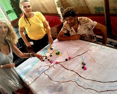 a group of people standing around a table with a map