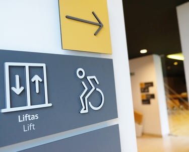 A sign that says "lift" and " way to the right for people with disabilities.