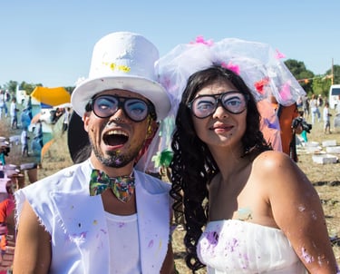 a man and woman in wild, zany white wedding attire