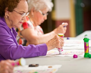 a woman sitting at a table with a bottle of wine