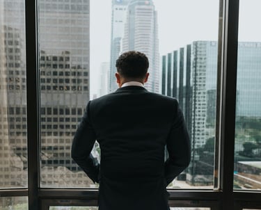 Frustrated business leader overlooking skyscrapers, symbolizing ERP software selection challenges