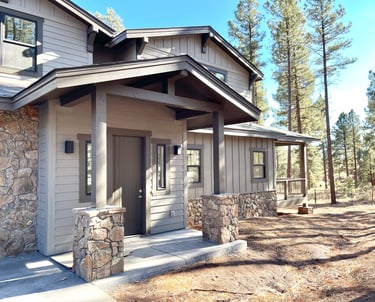 custom home with a stone exterior and a stone porch