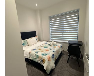 a neat bedroom with a bed and a desk