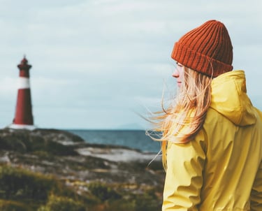 a woman in a yellow jacket and a red hat