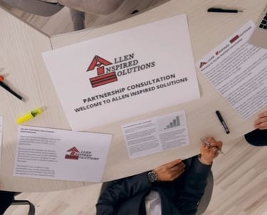 a group of people sitting around a table with AiS partnership papers