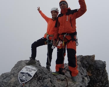 our clinets standing on top of a mountain Carstensz Pyramid - West Papua