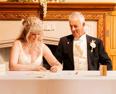 Couple Signing Certificate At Their Tying The Knot Ceremony