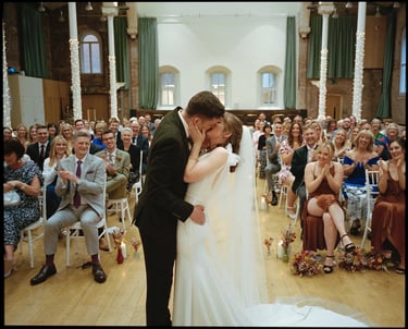 Couple Kissing At Their Wedding Ceremony By David Allbutt