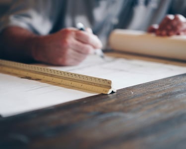 a man is working on a blueprint