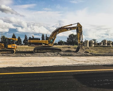 a construction site with a bulldozer and a truck