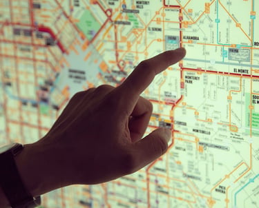 a person pointing at a map of a map of a map of a city