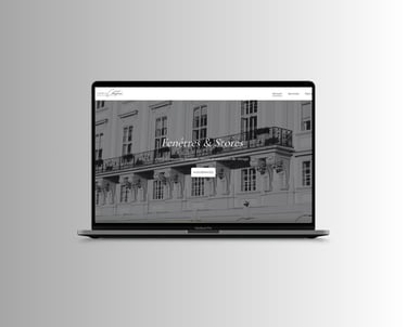Laptop displaying a modern website design for a French window and blind installation service.