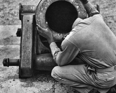 Man with afro looking into cannon