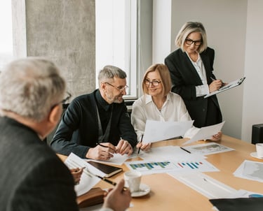 Group of advisors collaborating at a work table, consulting and sharing expertise