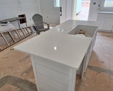 close up of quartz on a island with farm sink