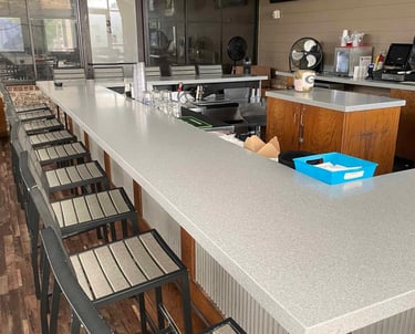 close look at a C shape granite countertop for bar area