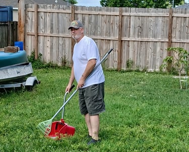 Robert using a sanitized scooper to remove waste from a customers back yard