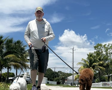 robert walking customers dogs in port saint lucie wearing a back's yard poop scooping shirt