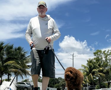 robert walking customers dogs in port saint lucie wearing a back's yard poop scooping shirt
