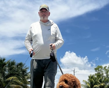 robert walking customers dogs in port saint lucie wearing a back's yard poop scooping shirt
