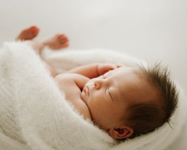 newborn baby peacefully sleeping, captured during a natural light newborn photography session