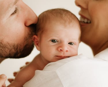 tender moment between baby and parents, part of a newborn lifestyle photography session in Adelaide