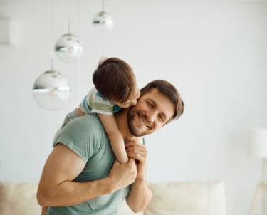 a man holding a child in his arms martin pe coach de pareja