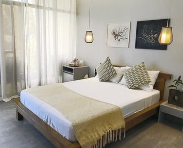 a bed with a white bed and a lamp