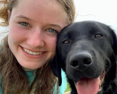 a dog and her student puppy raiser pose for a selfie