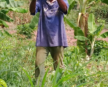 a man holding a watermelon in a field