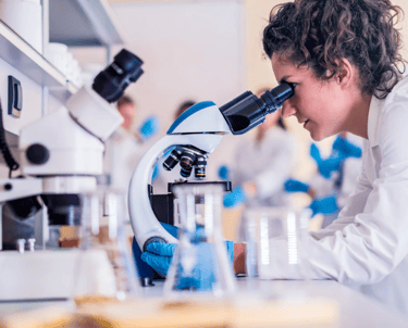 Scientist looking through a microscope