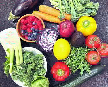 Variety of vegetables and fruits e.g. berries, kale, tomatoes, carrots, peppers, broccoli, lemon