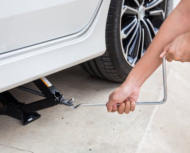 a person lifting jack with handle