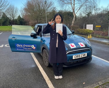 A girl standing in front of a mini cooper owned by Chris Craven Driving School