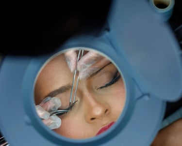 a woman is shown in a mirror and is looking at her eyeliners